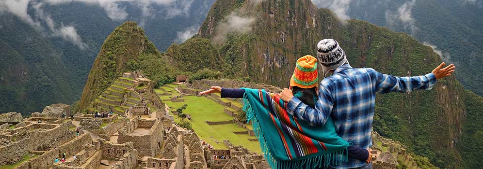 Two people celebrating reaching Machu Picchu