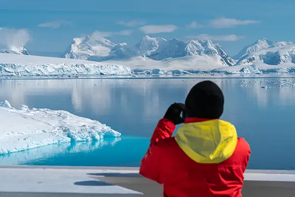 A traveler looks in the distance in Paradise Bay, Antarctica (c)Hurtigruten