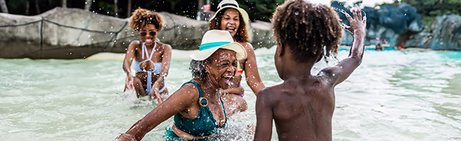 Grandmother playing with Grandson in a pool