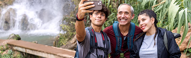 Two teens taking selfie with grandfather