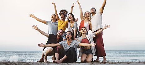 Group of employees celebrating on the beach