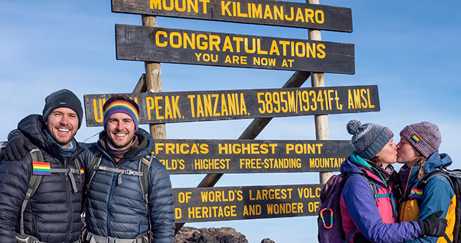 Lesbian and gay hikers atop Mount Kilimanjaro