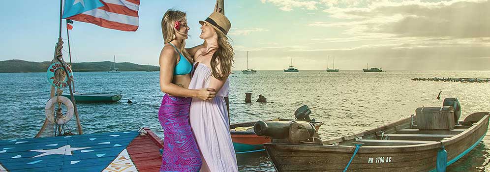 Two women kissing on a pier in Puerto Rico