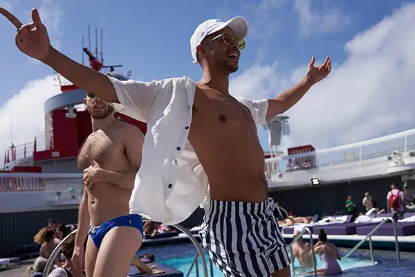 A young adult man parties on a Virgin Voyages ship