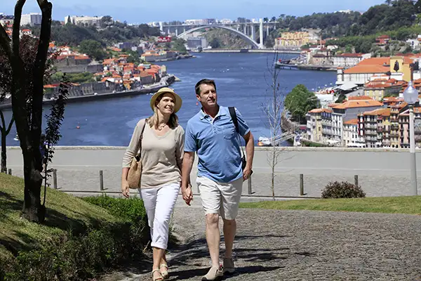 A couple strolls through Porto on an AmaWaterways cruise