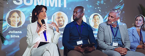 Panelists on stage at a business summit