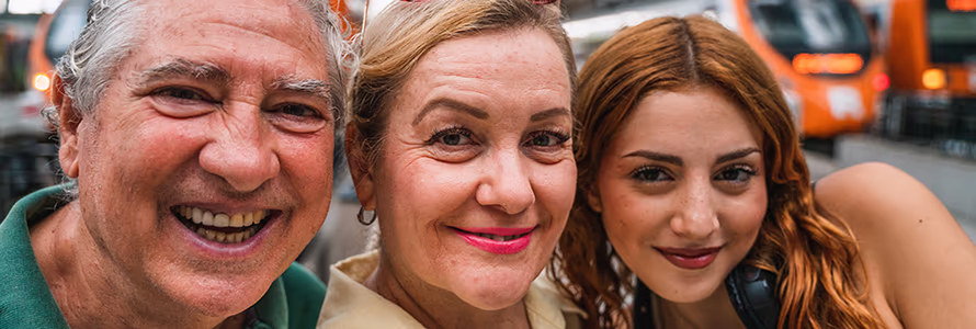 Two grandparents with their teenaged granddaughter at a train station