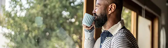 Man contemplates while enjoying a cup of tea