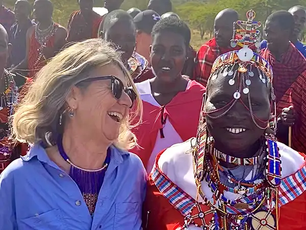 Woman laughing with Maasai friend
