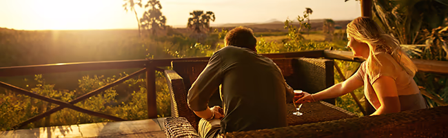 A couple stares out over the jungle from their villa